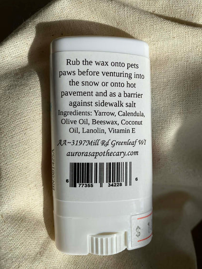 White stick with text and a barcode on a textured beige background with ingredient and directions.